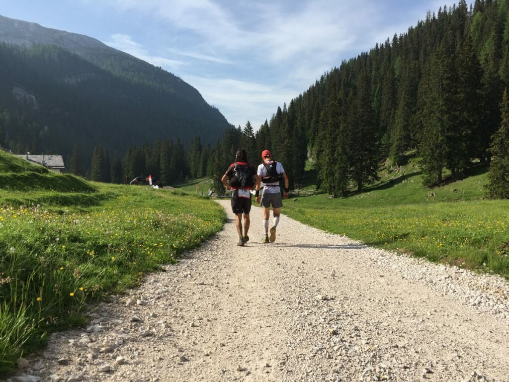 Two runners supporting each other through difficult times